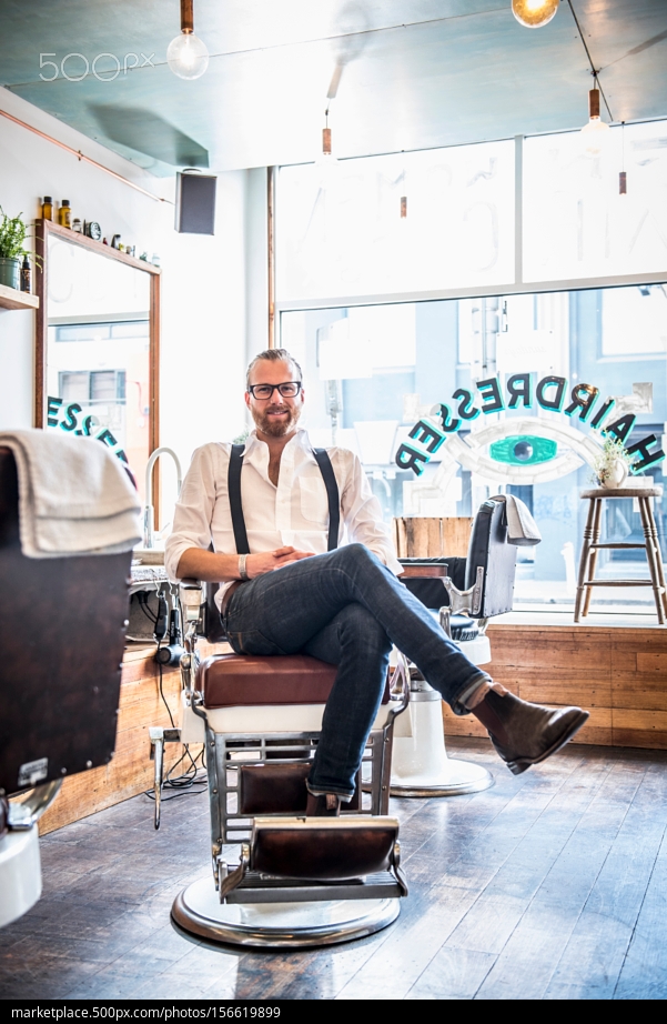 500px Photo ID: 156619899 - Caucasian stylist smiling in barber shop - Jago